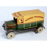 A Wells (UK) tinplate and clockwork Express Transport delivery van comprising of cream and green