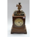 A late 19th century continental walnut cased mantel clock, having a painted dial with Roman numerals