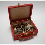 A red leather clad jewellery box and contents to include mainly modern costume jewellery