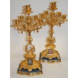 A pair of large late 19th century gilt metal five sconce candelabra, each with inset plaque