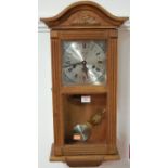 A Lincoln beech cased droptrunk wall clock, with pendulum and key