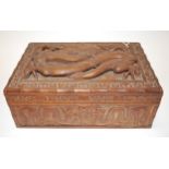 An early 20th century Chinese carved camphorwood fitted box, the cover as a raised dragon within
