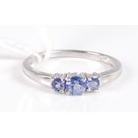 A modern 14ct white gold and tanzanite three stone ring, 2g, size N