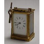 A mid-20th century lacquered brass cased carriage clock, having an enamelled dial with Roman