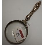 A circa 1900 continental magnifying glass, the handle with repoussee decoration, the rim stamped