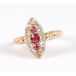 An 18ct gold, ruby and diamond dress ring, the elliptical setting as three central round cut