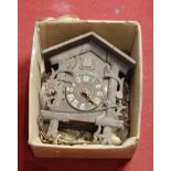 An early 20th century continental carved softwood cased cuckoo clock