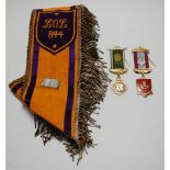 An Orange Order sash with modern William III 1690 badge, together with a silver gilt and enamelled