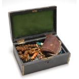 An early 20th century leather clad jewellery box and contents, to include George VI and Elizabeth II