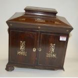 A circa 1830 rosewood and mother of pearl inlaid workbox of sarcophagus form, the hinged lid