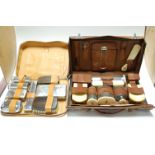 An early 20th century gentleman's brown leather travel case and contents to include various ivory