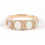 An 18ct gold, opal and diamond set ring, arranged as four graduated cabochon opals, each dispersed