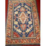 A small Persian blue ground woollen rug, having a geometric floral decorated ground within