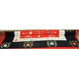 A Caucasian machine woven red ground floral decorated carpet