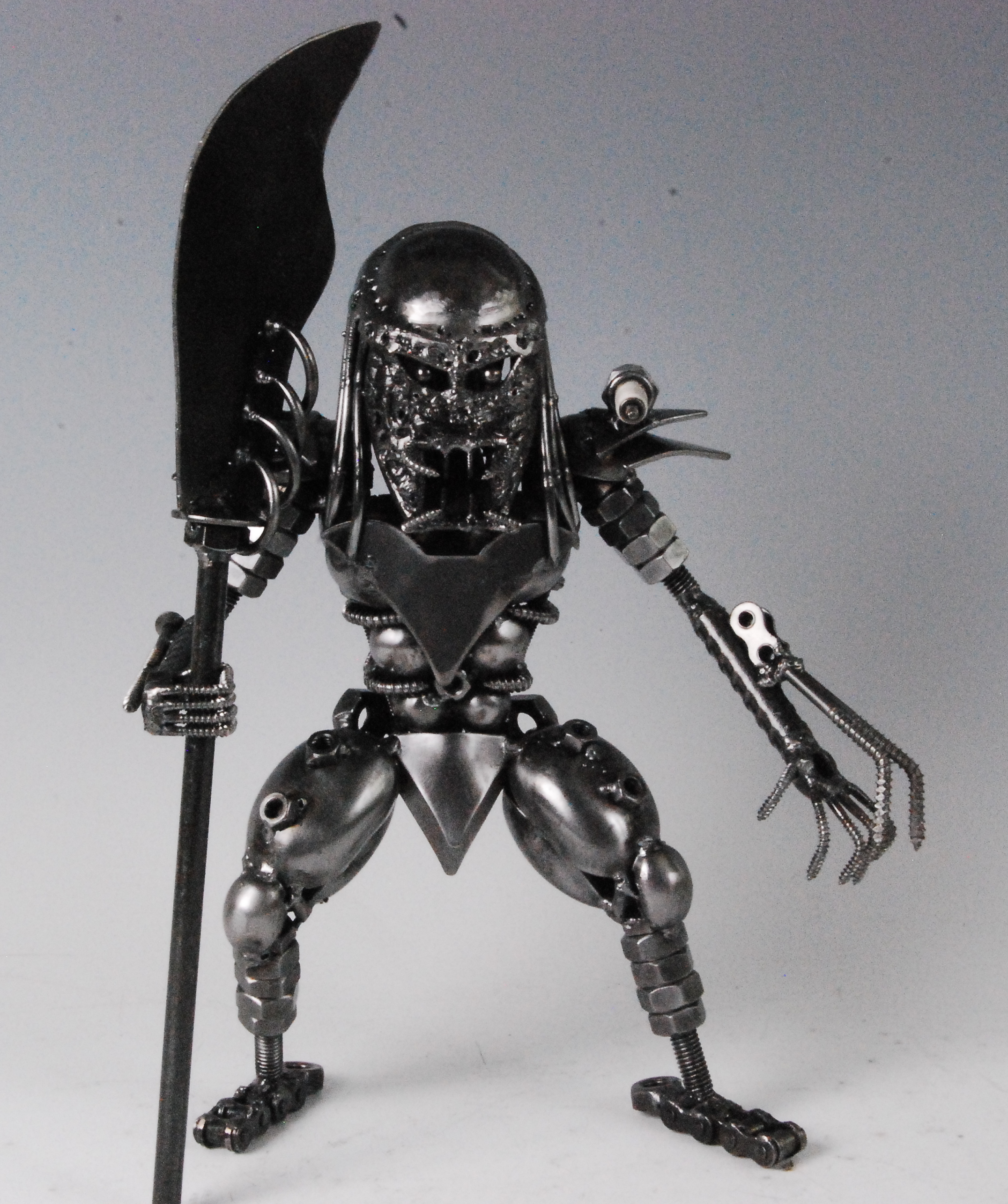 A scrap metal art sculpture of Predator, with spear, h.29cm