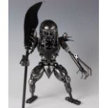 A scrap metal art sculpture of Predator, with spear, h.29cm