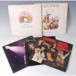 A collection of five Queen vinyl records to include