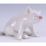 A Royal Copenhagen porcelain model of a seated Pig, printed backstamp and numbered 414 verso, h.