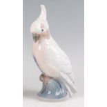 A Royal Copenhagen porcelain model of a perched Cockatoo, designed by Dahl Jensen, printed backstamp