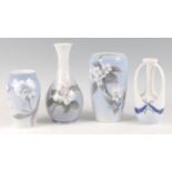 A Royal Copenhagen collection of four various porcelain floral decorated vases, comprising bottle