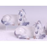 A pair of Royal Copenhagen porcelain models of recumbent foals, each with printed backstamps and