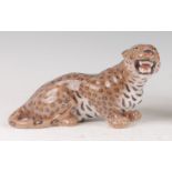 A Royal Copenhagen porcelain model of a Leopard, in perched recumbent pose, printed backstamp and