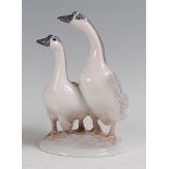 A Royal Copenhagen porcelain model of a pair of geese, designed by Peter Herald, printed