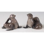 A Royal Copenhagen porcelain model of a pair of Sealions, printed backstamp and numbered 328