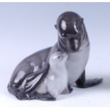 A Royal Copenhagen large porcelain figure group of a Seal with pup, in seated pose, printed