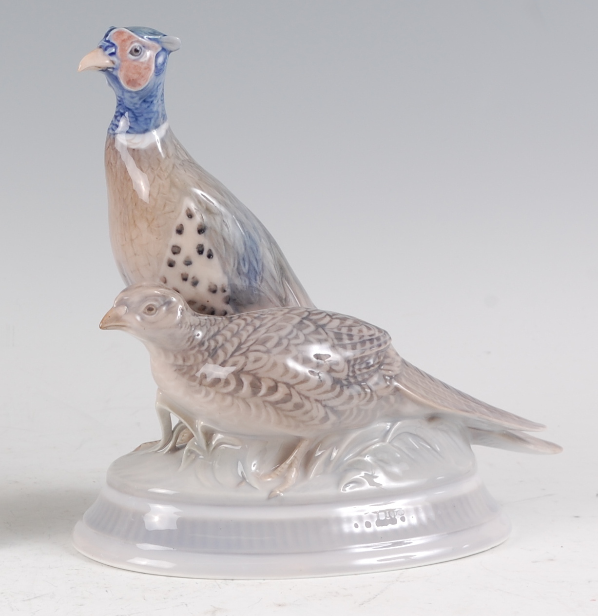 A Royal Copenhagen porcelain model of a pair of Pheasants, printed backstamp and numbered 1951