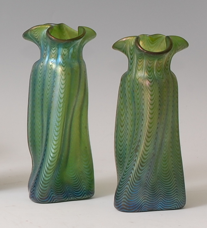 A pair of possibly Loetz early 20th century green glass vases, each having iridescent trailing