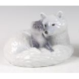 A Royal Copenhagen large porcelain model of an Arctic Fox with cub, in recumbent pose, printed