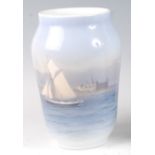 A Royal Copenhagen porcelain vase, decorated with a sailing boat and palace with further buildings