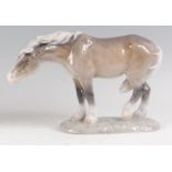 A Royal Copenhagen porcelain model of windswept Horse, in standing pose, after the original by