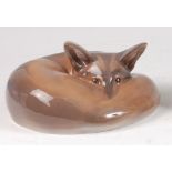 A Royal Copenhagen porcelain model of a Fox ' curled', designed by Erik Neilsen, printed