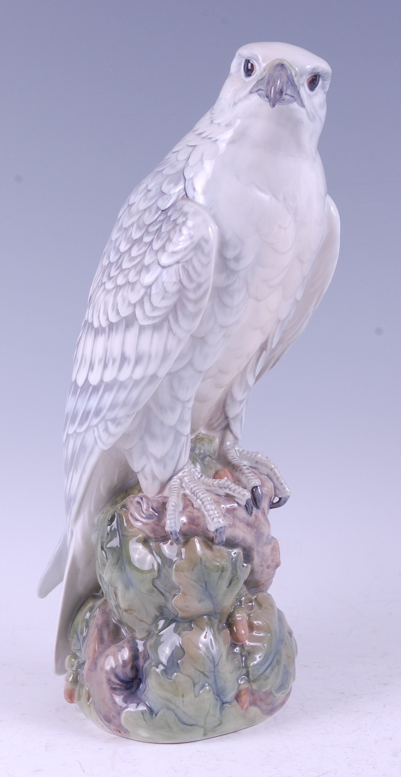 A Royal Copenhagen large porcelain model of an Icelandic Falcon, perched on acorn stump outcrop,