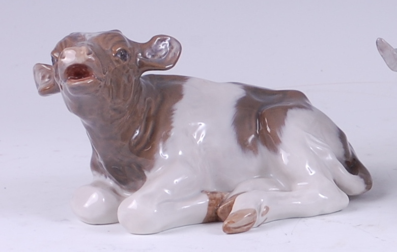 A Royal Copenhagen porcelain model of a recumbent calf, printed backstamp, numbered 1072 and