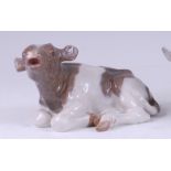 A Royal Copenhagen porcelain model of a recumbent calf, printed backstamp, numbered 1072 and