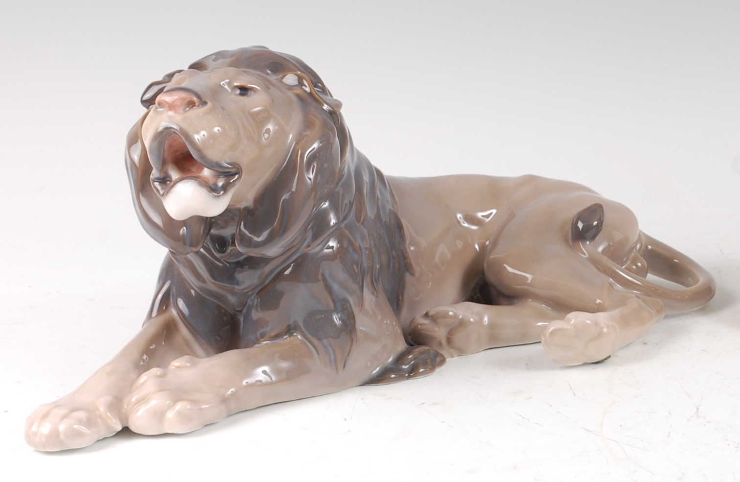 A Royal Copenhagen large porcelain model of a recumbent Lion, printed backstamp, numbered 1268 and