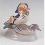 A Royal Copenhagen porcelain model of a pair of Mandarin Ducks, designed by Peter Herold, printed