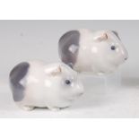 A pair of Royal Copenhagen porcelain models of Guinea Pigs, each with printed backstamps and