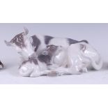 A Royal Copenhagen porcelain model of recumbent Cow with calf, printed backstamp, numbered 800 and