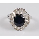 A white metal sapphire and diamond oval cluster ring, the ring having a centre oval faceted sapphire