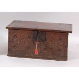 A circa 1700 joined oak Bible box, the hinged lid with iron strapwork hinges, above a carved