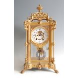 A late 19th century gilt metal four glass mantel clock, having Baroque influenced case, white enamel