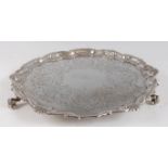 A George II silver salver, having floral and C-scroll engraved decoration within raised C-scroll and