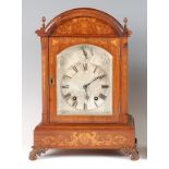 A late 19th century German rosewood and marquetry inlaid mantel clock, having a domed top with