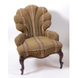 A Victorian rosewood framed nursing chair, in probably original striped upholstery, with shaped back