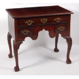 A George III mahogany lowboy, the top having a moulded edge over an arrangement of three drawers