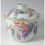 A 19th century Chinese celadon ware bowl and cover, decorated in the famille rose palette with